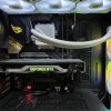 Detailed view of a gaming PC build featuring a GeForce RTX graphics card and RGB lighting in a sleek black case.